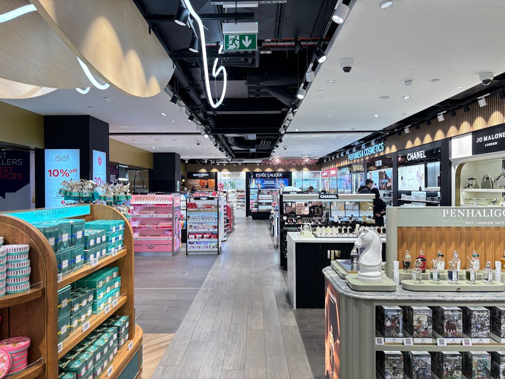 Bright cosmetics store interior showcasing luxury brands in London. Sleek and modern retail design.